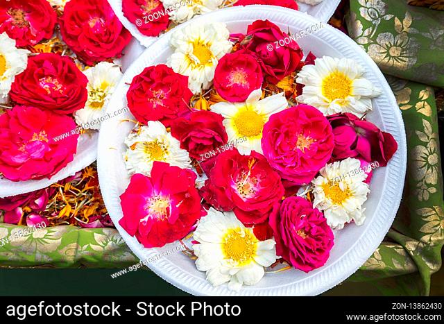 Red  and white Flowers on market. Indian traditional form of the Bouquet on a plate (possible - for religious Hinduism purposes )