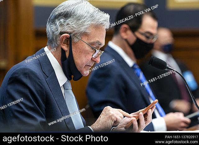 Federal Reserve Chair Jerome Powell (L) and Treasury Secretary Steven Mnuchin (R) prepare to speak at a House Financial Services Committee hearing on ‘Oversight...