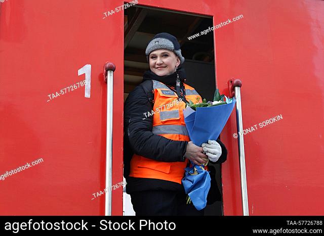 RUSSIA, YEKATERINBURG - MARCH 6, 2023: Long distance passenger train driver Oksana Sokolova holds flowers ahead of her first solo run
