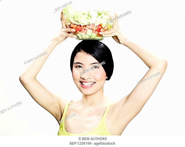 Teenage girl making salad