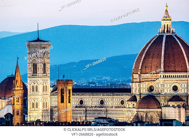 Florence, Tuscany, Italy. cityscape and Cathedral and Brunelleschi Dome, Giotto Tower. Sunset, lights on