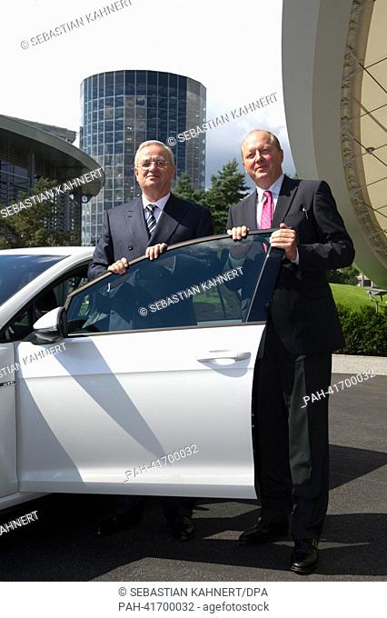 CEO of Volkswagen Martin Winterkorn (L) and General Manager of the Car City Otto Wachs stand next to a Golf GTD at the new course in the VW Car City in...