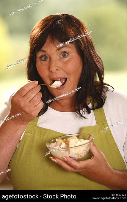 Woman with bowl fruit salad with yoghurt, bowl, spoon, try, tasted