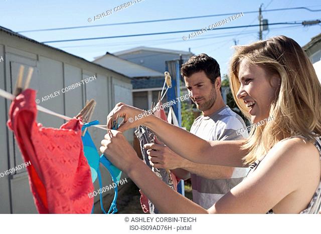 Couple hanging out washing, Breezy Point, Queens, New York, USA