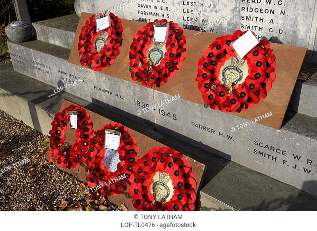 England, Suffolk, Aldeburgh, Poppy wreaths with messages laid upon a War Memorial in Aldeburgh