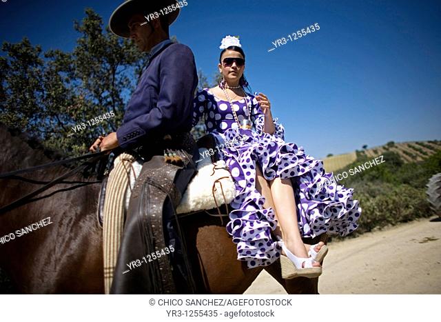 Riders wear traditional Andalusian clothes during a romeria, or pilgrimage, in honor of San Isidro Labrador, the patron of farmers, in Prado del Rey village