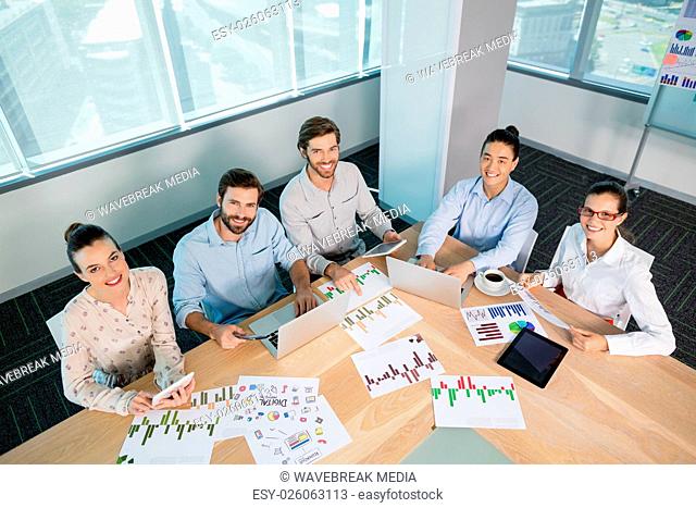 Smiling business executives working in conference room