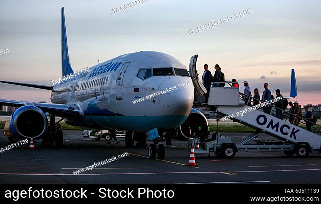 RUSSIA, OMSK - JULY 17, 2023: Passengers board a Boeing 737-800 plane of Pobeda at Omsk Central International Airport named after Dmitry Karbyshev (1880-1945)