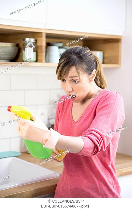 Woman using a conventional cleaning product