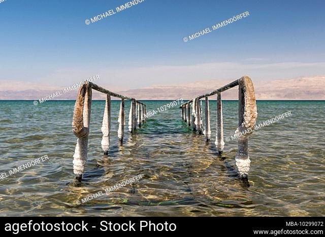 Middle East, Israel, Dead Sea, En Gedi, salt deposit on railing at swimming area with clear water