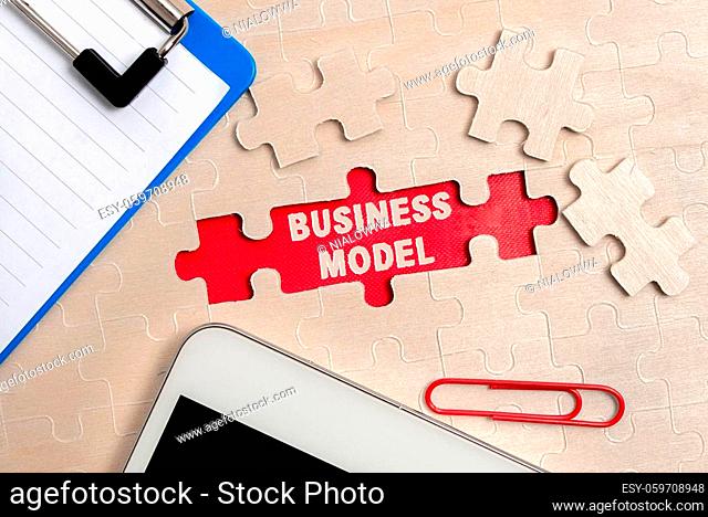 Writing displaying text Business Model, Business showcase model showing how a company operates to generate more profit Building An Unfinished White Jigsaw...