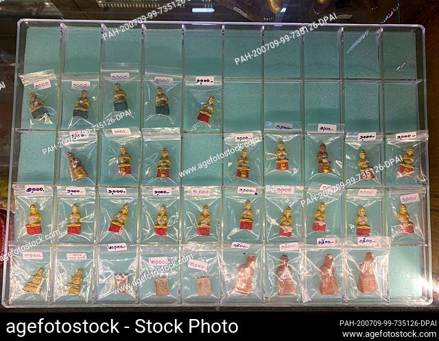 23 June 2020, Thailand, -: Kuman Thong figures are sold at the temple Wat Samngam. One Kuman Thong figurine, rumoured to contain ashes with human remains