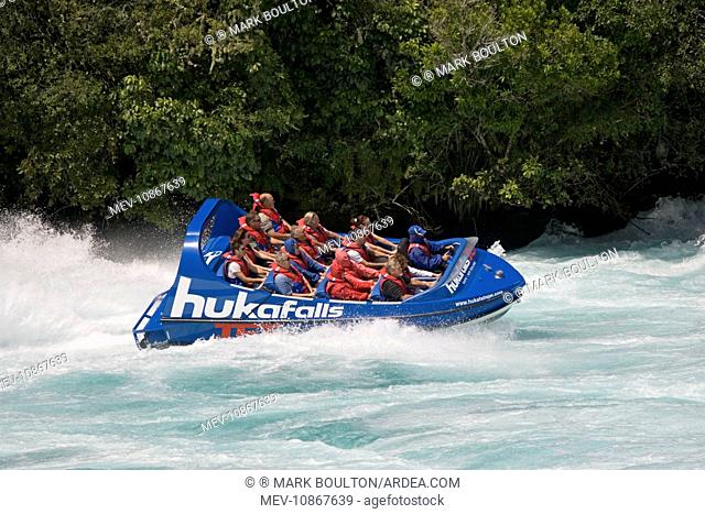 Tourists in Huka Falls jet boat Waikato River. Taupo North Island New Zealand