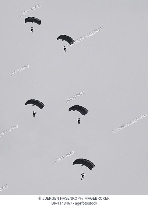 Paratroopers gliding in the air in formation with paragliders, 13th International Paratrooper Competition of the Special Operations Division