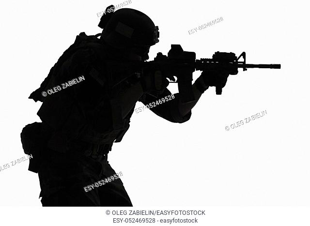 United states Marine Corps special operations command Marsoc raider with weapon aiming a gun. Silhouette of Marine Special Operator white background