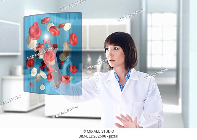Mixed race doctor using digital display in doctor's office