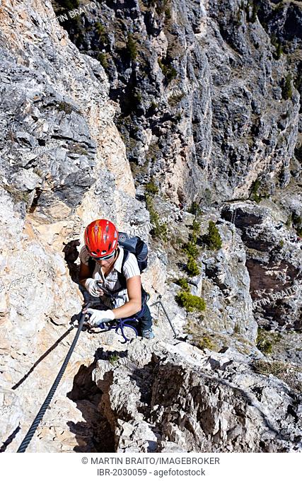 Climber during the ascent of the Stevia climbing route in the Vallunga Valley in Selva di Val Gardena, Alto Adige, Austria, Europe
