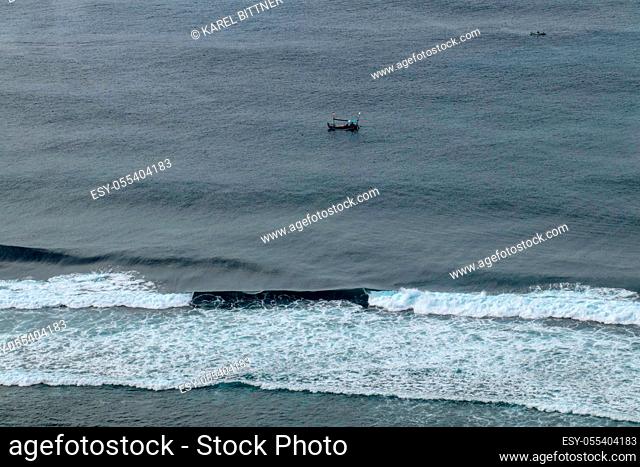 Aerial view of Nyang Nyang beach on Bali in Indonesia. A popular spot of surfers with big waves in the Indian Ocean. Fishing boats of Balinese fishermen on the...