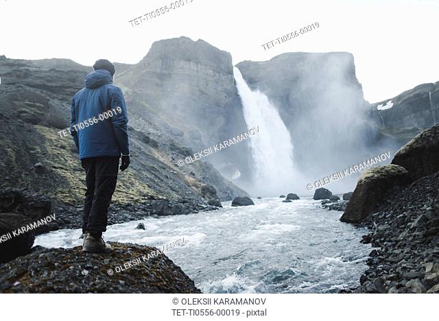 Hiker by Haifoss waterfall in Iceland