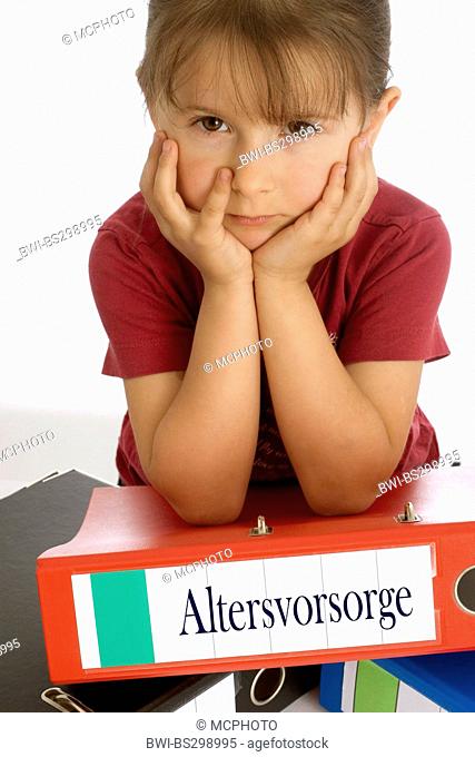 little girl seriously leaning on a file with the inscription 'Altersvorsorge' ('retirement planning')
