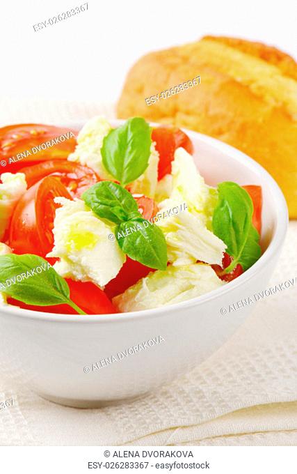 bowl of caprese salad and fresh bun