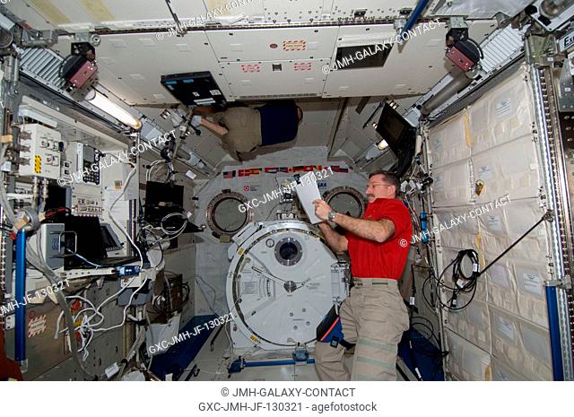 NASA astronaut Dan Burbank, Expedition 30 commander, reviews crew procedures in the Kibo laboratory of the International Space Station as crew members prepare...