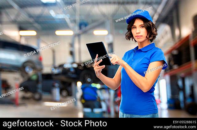 female worker with tablet pc at car service