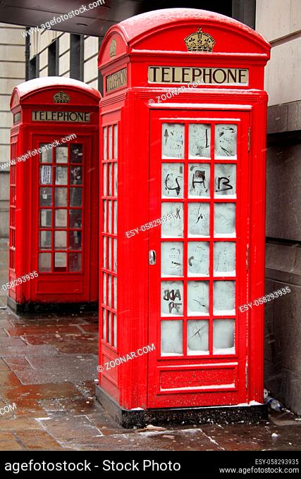 Traditional red London telephone booth in winter, England