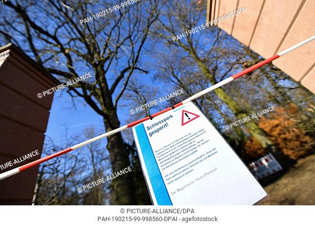 13 February 2019, Hessen, Offenbach/Main: A barrier tape and a sign with the inscription ""Schlosspark gesperrt!"" are attached to an entrance to the...