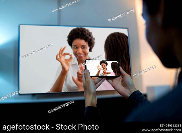 Woman Watching TV Through Smartphone And Streaming Movie