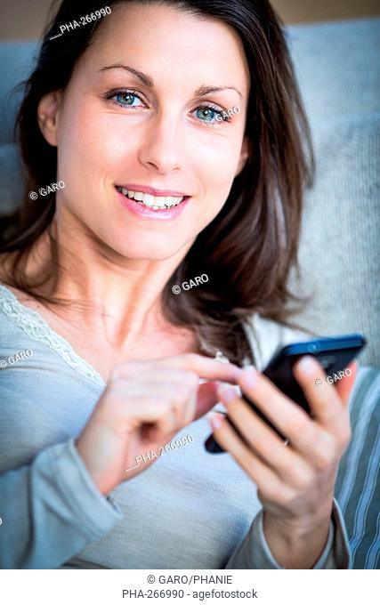 Woman touching the screen of a smartphone