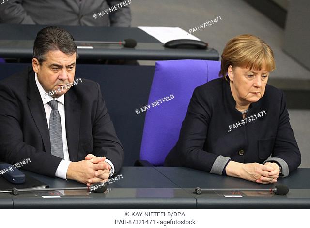 German Minister of Economic Affairs Sigmar Gabriel (SPD, L) and German Chancellor Angela Merkel (CDU) sit in the Bundestag in Berlin, Germany, 19 January 2017