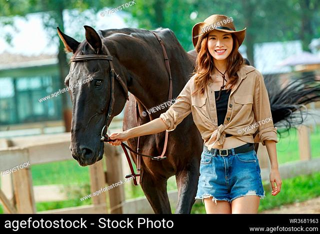 The horse young woman of fashion and personality