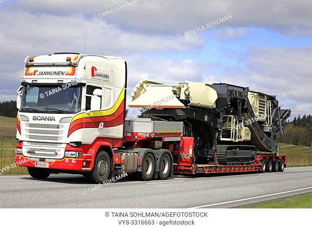 Salo, Finland - May 3, 2019: Scania R730 semi trailer of Janhunen pulls Metso Lokotrack LT1213S mobile crushing and screening plant on low bed trailer