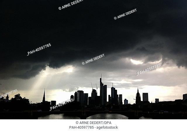 Dark clouds are visible above the skyline of the financial district of Frankfurt Main, Germany, 27 June 2013. Photo: Arne Dedert | usage worldwide