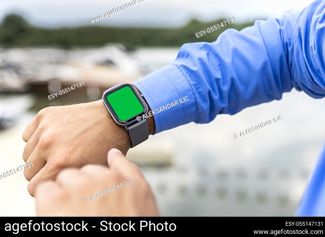Smart watch on the man's hand with chroma key display for copy space, add text or logo