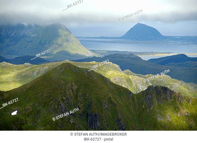View to mountains in sun and shadow from the summit of Justadtinden Vestvagoya Lofoten Norway