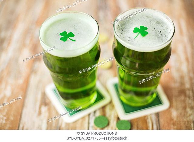 glasses of green beer with shamrock and gold coins