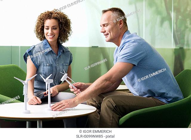 Young woman in meeting with mature man about wind turbine