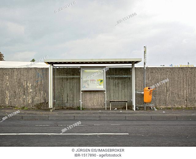 Deserted bus stop in front of a concrete wall, Bonn, North Rhine-Westphalia, Germany, Europe