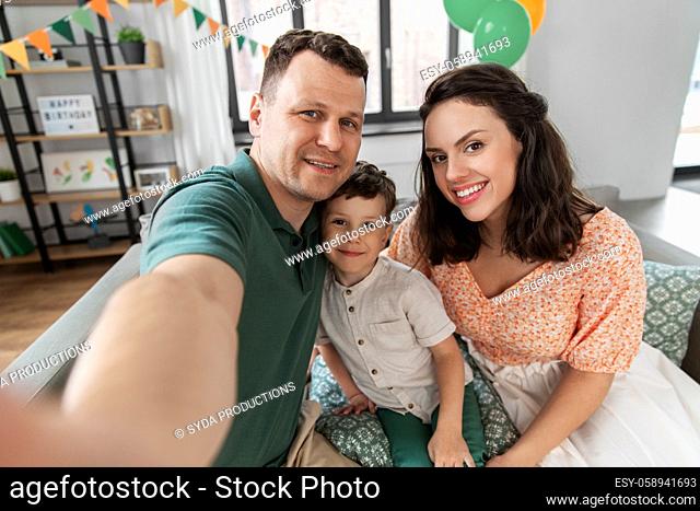 happy family taking selfie on birthday at home
