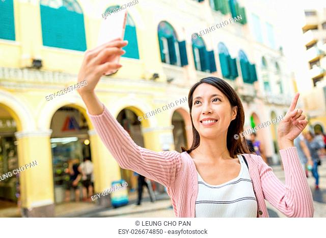 Woman take photo by cellphone in Macau