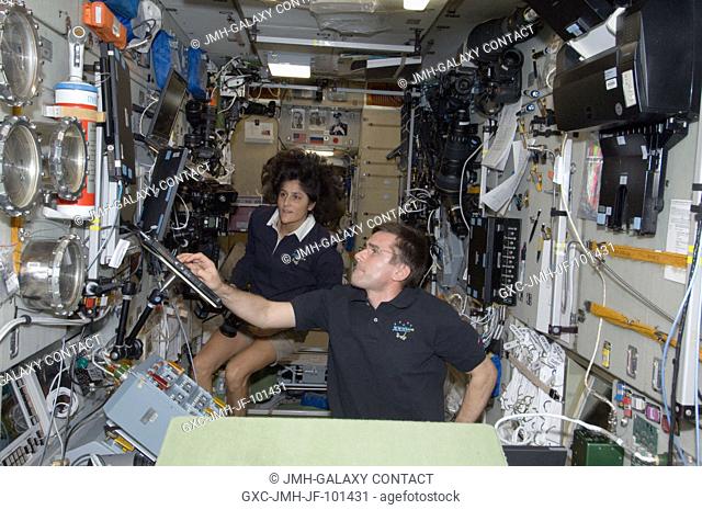 NASA astronaut Sunita Williams, Expedition 33 commander; and Russian cosmonaut Yuri Malenchenko, flight engineer, work in the Zvezda Service Module of the...