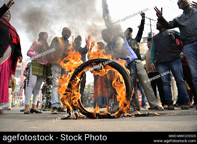 Congress supporters burning tires in front of the state Congress Head Office during a protest against the attack on the PCC president