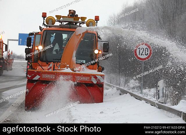 12 February 2021, Thuringia, Gera: A snow blower removes snow from the emergency lane on motorway 4. Photo: Bodo Schackow/dpa-zentralbild/dpa