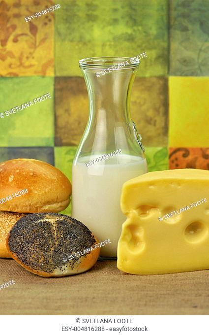 milk bottle , cheese and fresh rolls