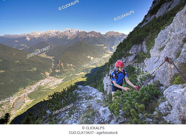 Mountain climber on the via ferrata Fiamme Gialle at Palazza Alta of Pelsa, Civetta group, Agordo, Dolomites, Veneto, Italy, Europe