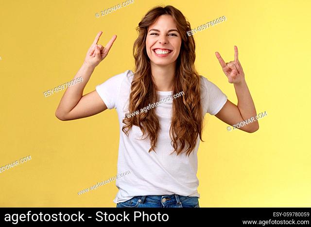 Enthusiastic charismatic lucky girl having fun enjoy awesome music show rock-n-roll gesture grinning thrilled like heavy-metal dancing upbeat positive standing...