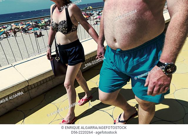 Couple walking, Poniente beach, Benidorm, Alicante province, Spain