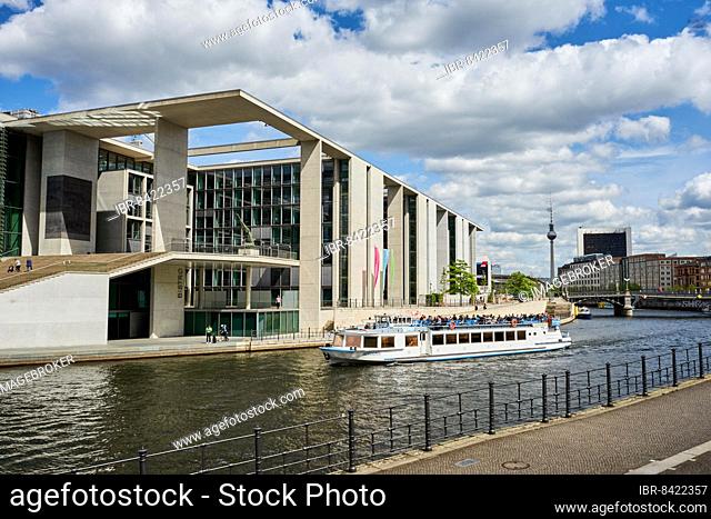 Marie-Elisabeth-Lüders-Haus designed by architect Stephan Braunfels, in front the Spree with a pleasure boat, Berlin Mitte, Berlin, Germany, Europe